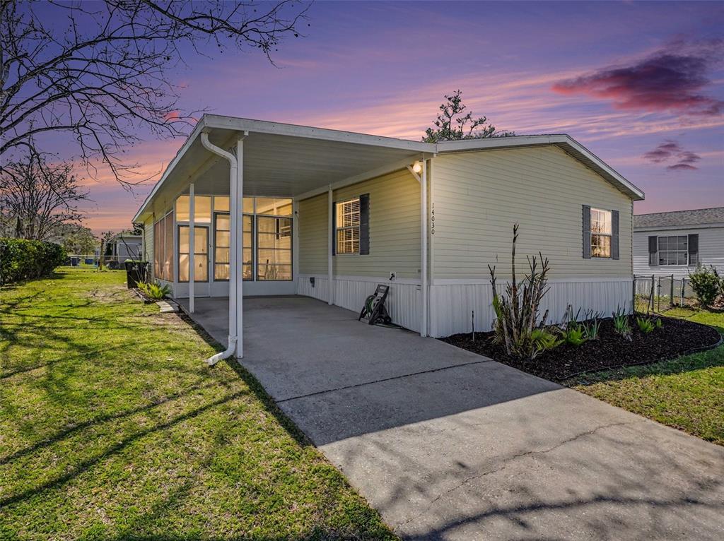 a front view of a house with a yard and potted plants