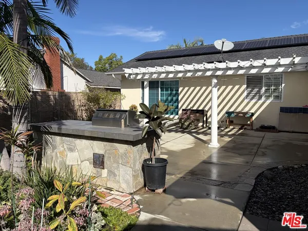a view of a patio with table and chairs potted plants