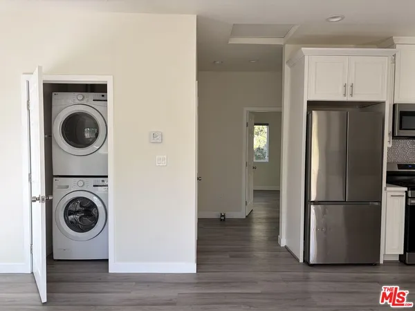 a kitchen with a refrigerator and washer