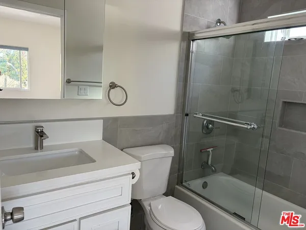 a bathroom with a toilet sink and shower