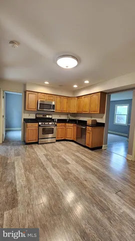 a view of kitchen with furniture and wooden floor