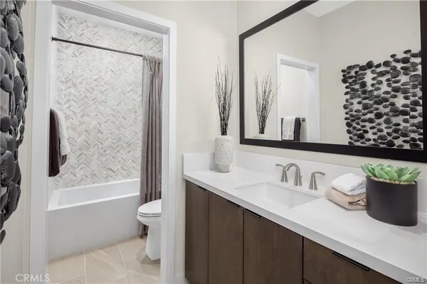 a bathroom with a sink a toilet and shower curtain
