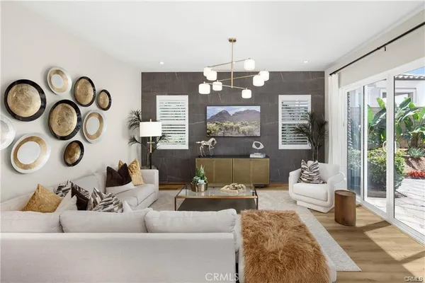 a living room with furniture and a chandelier