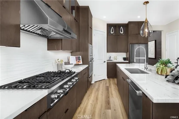 a kitchen with a sink stove top oven and cabinets