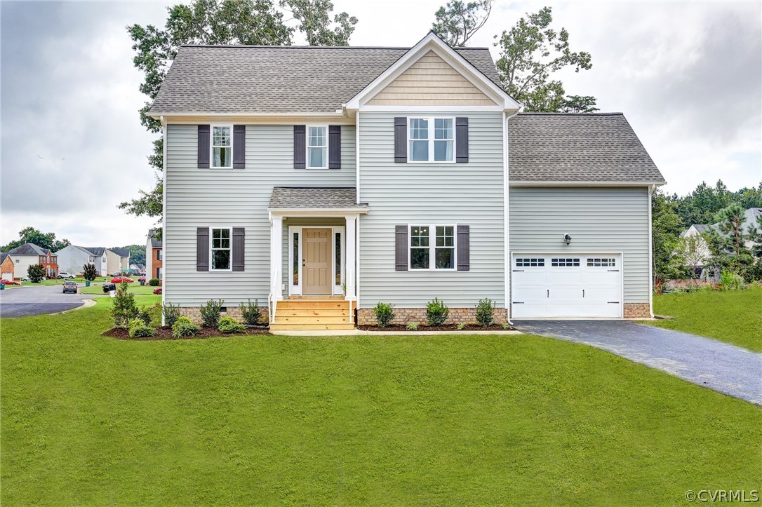 a front view of house with yard and green space