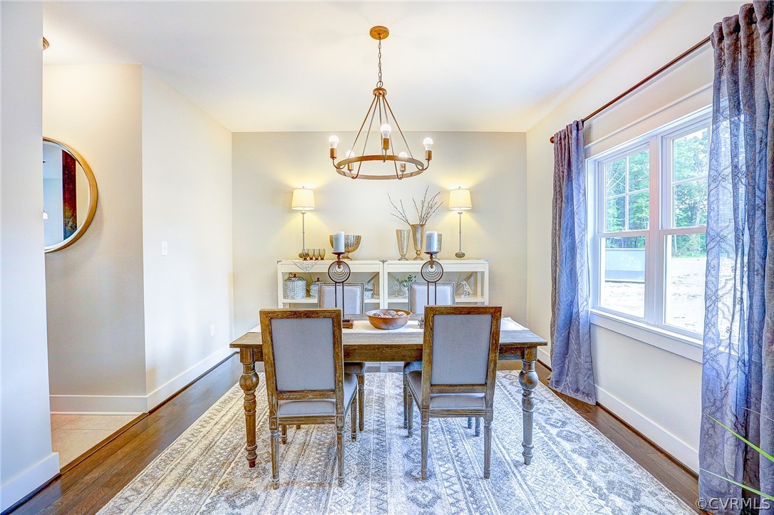 7213 Appelman Road Chesterfield, VA 23832 - Photo 6 of 18 a dining room with furniture a chandelier and wooden floor