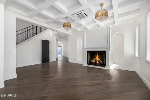 a view of an empty room with a fireplace and a window