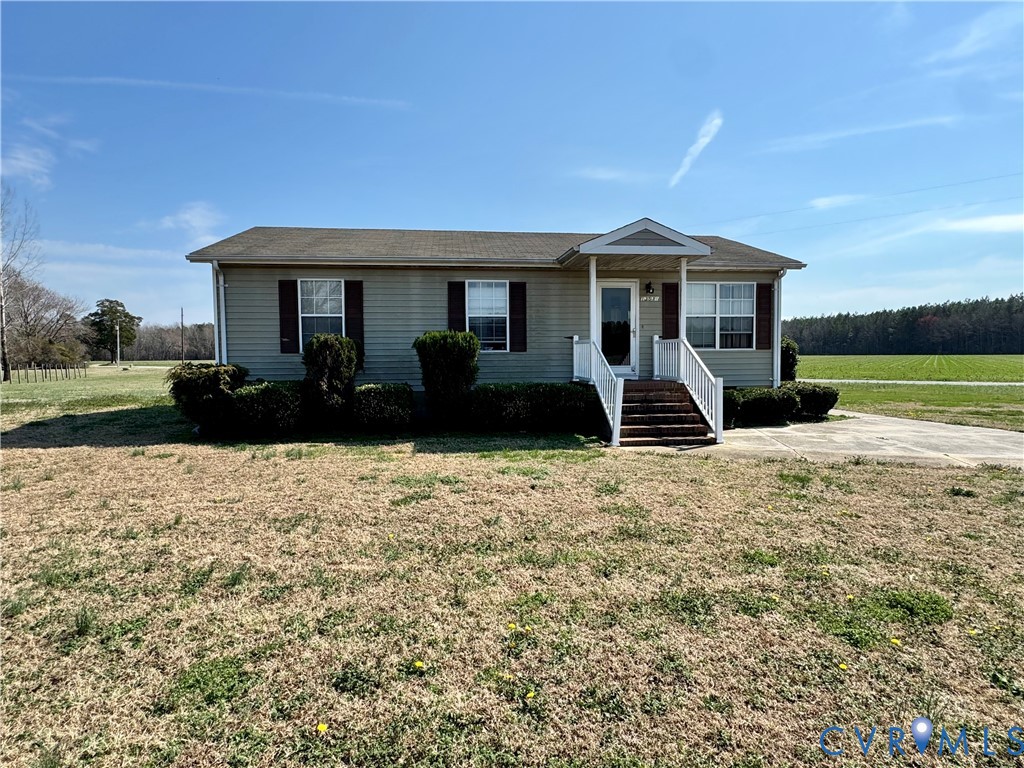 13531 Raynor Road Ivor, VA 23866 - Photo 2 of 16 a front view of a house with a garden