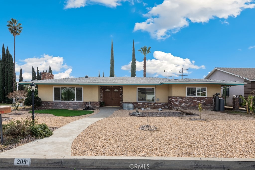 205 East Wabash Street Rialto, CA 92376 - Photo 1 of 1 a front view of a house with a patio