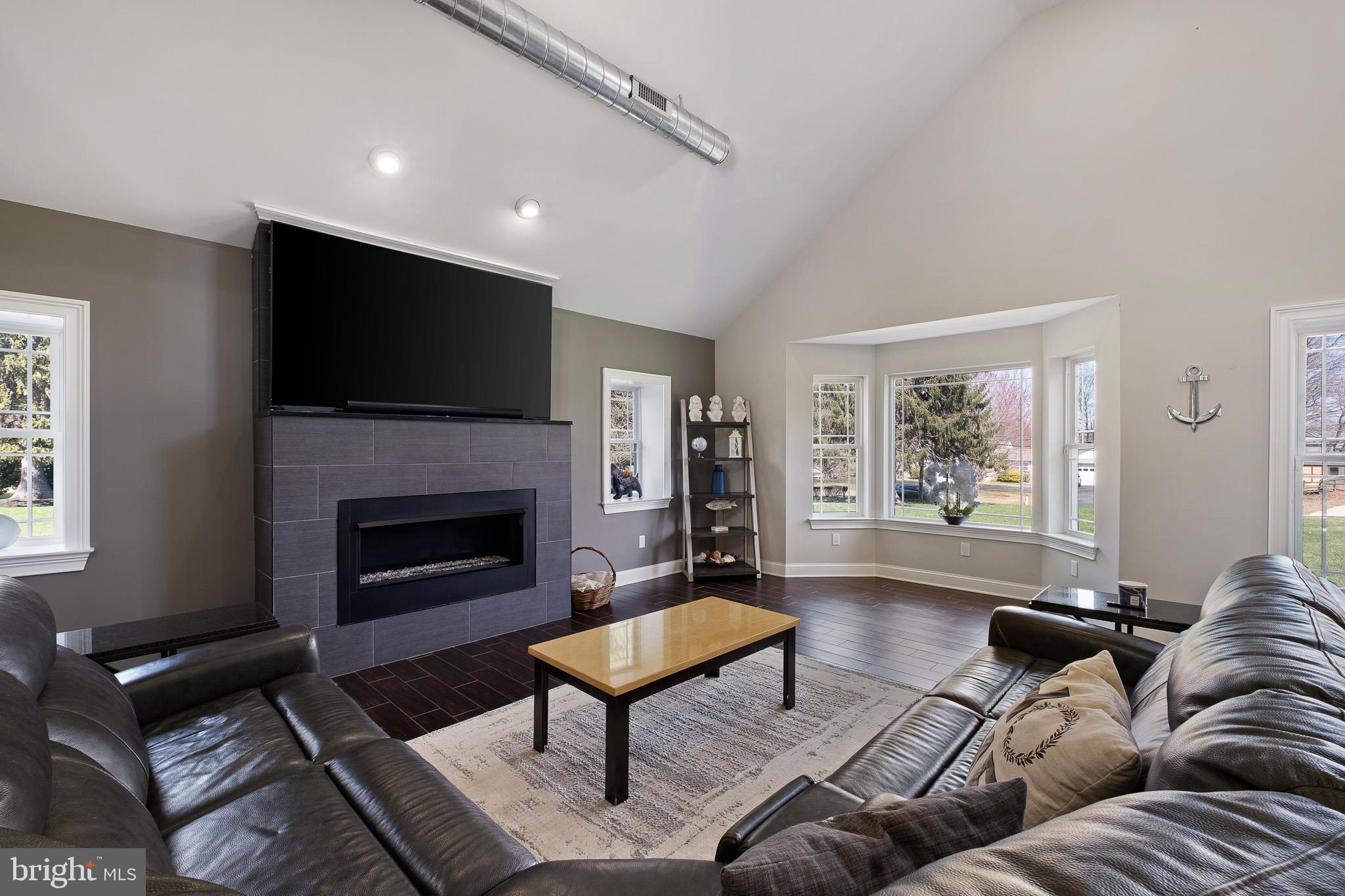 314 Concord Road Glen Mills, PA 19342 - Photo 17 of 42 a living room with furniture a flat screen tv and a fireplace