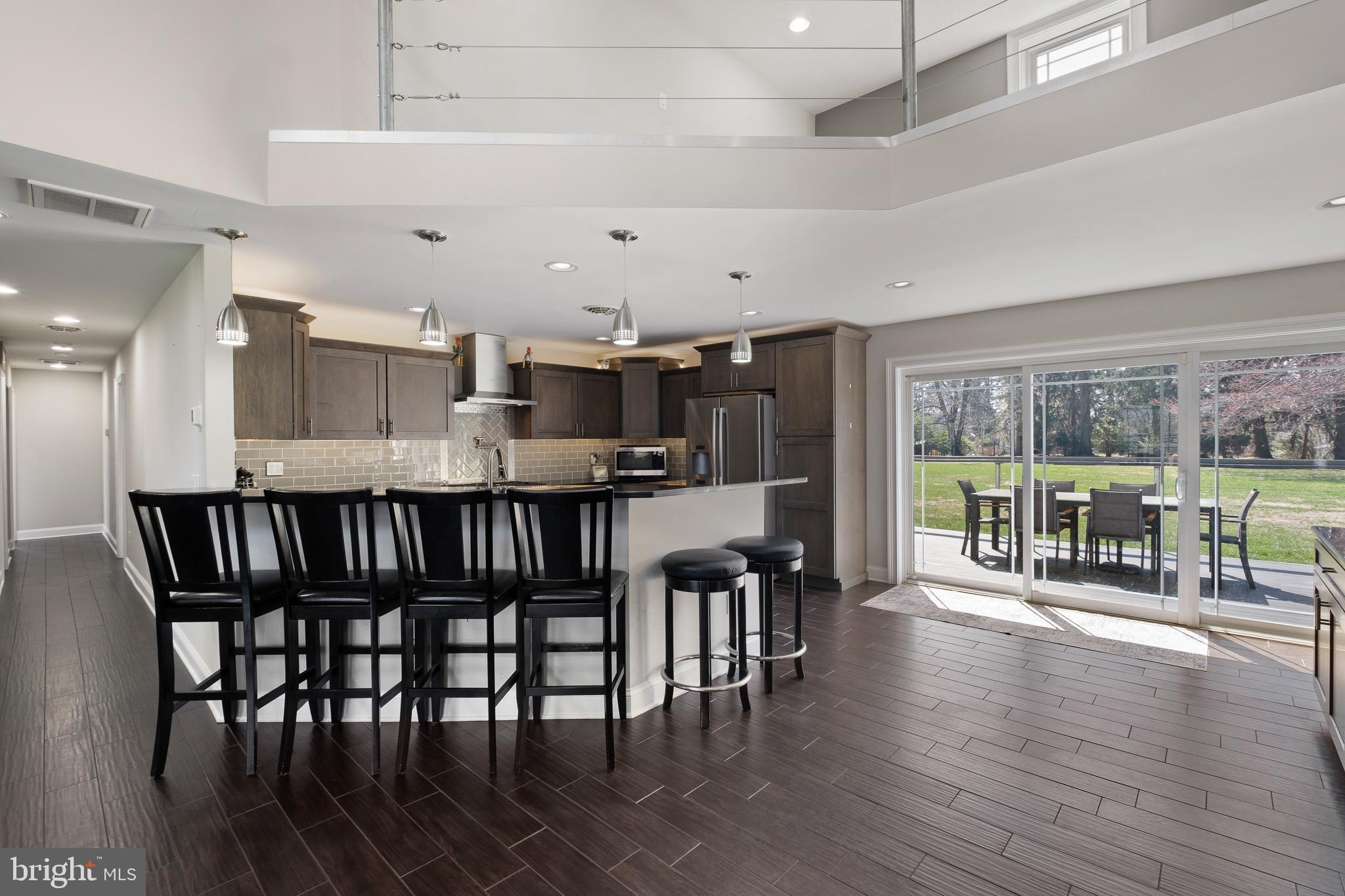 314 Concord Road Glen Mills, PA 19342 - Photo 19 of 42 a kitchen with stainless steel appliances granite countertop a dining table chairs and wooden floor