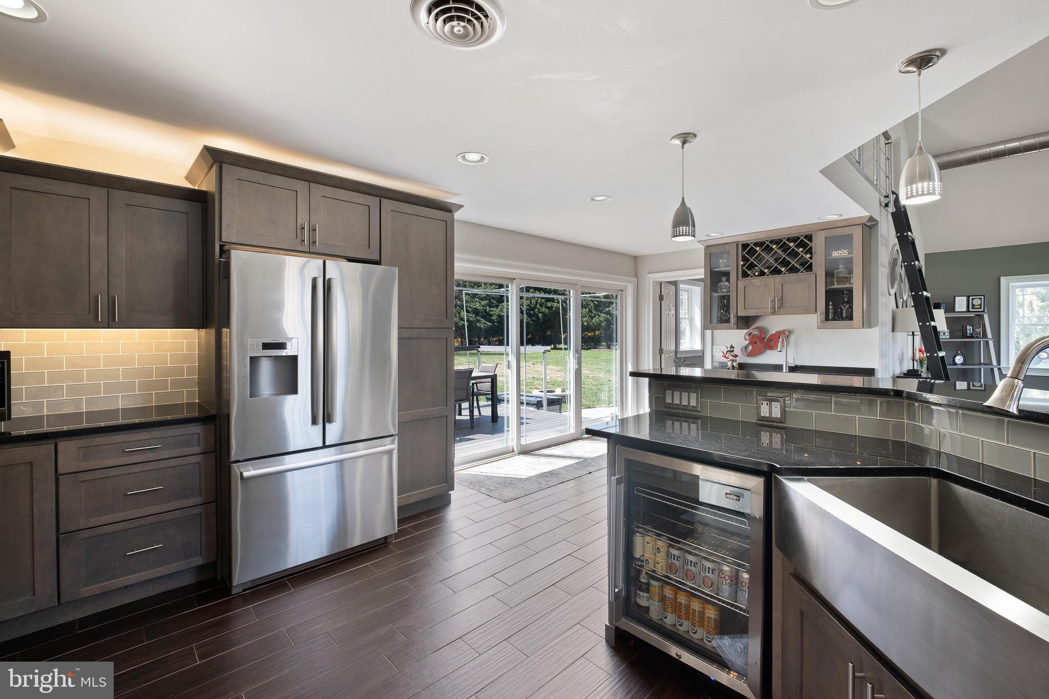 314 Concord Road Glen Mills, PA 19342 - Photo 23 of 42 a kitchen with stainless steel appliances wooden floor sink and wooden cabinets