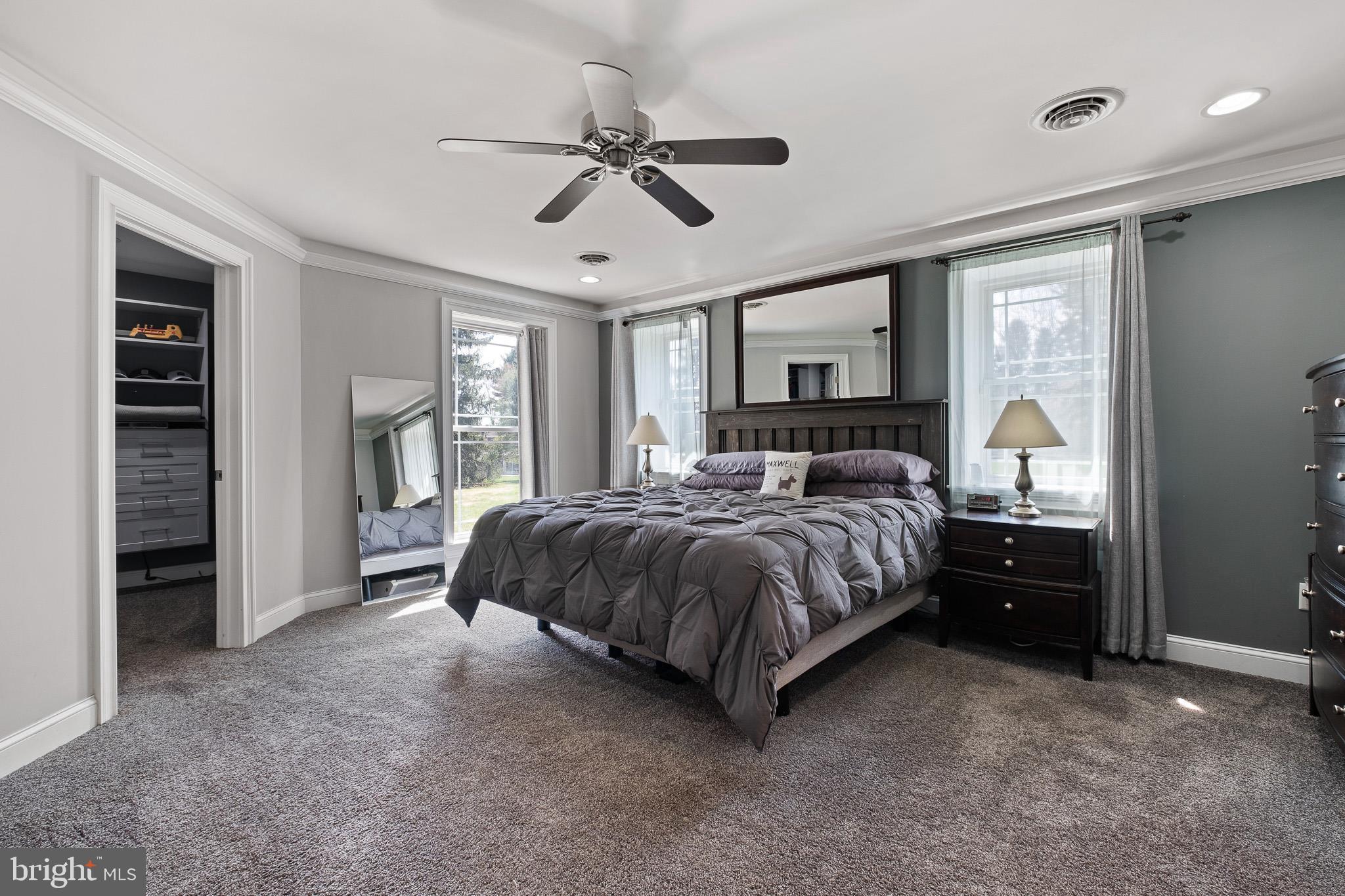 314 Concord Road Glen Mills, PA 19342 - Photo 24 of 42 a spacious bedroom with a bed a ceiling fan and a dresser