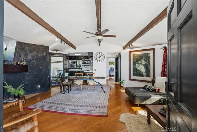 a living room with patio furniture dining table and a fireplace