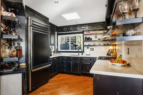 a kitchen with stainless steel appliances a sink stove and refrigerator