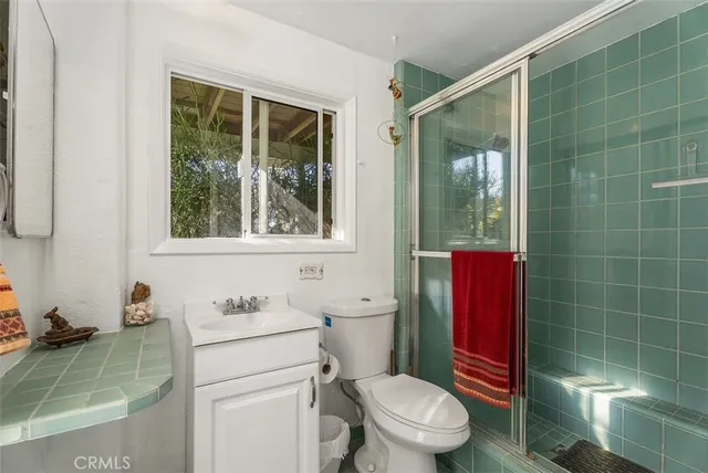 a bathroom with a toilet a sink and shower