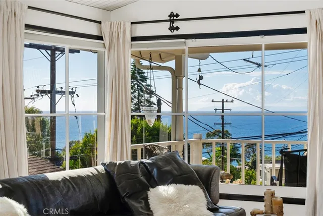 a balcony view with a large window and wooden floor