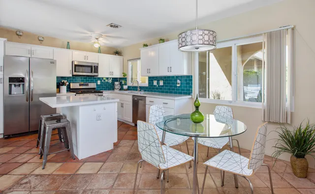 a view of a dining room with furniture a chandelier and wooden floor