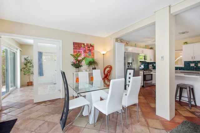 a view of a dining room with furniture and a potted plant