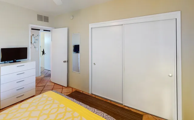 a room with a bed and a flat screen tv