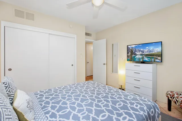 a bedroom with a bed and a flat screen tv