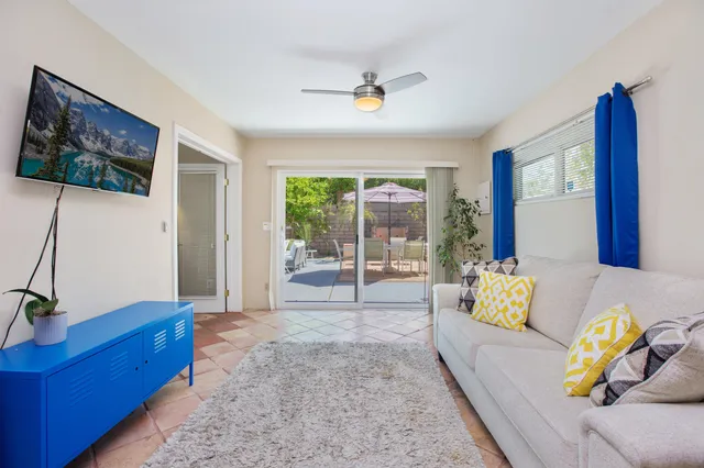 a living room with furniture and wooden floor