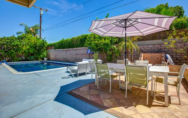 a patio with a patio table and chairs