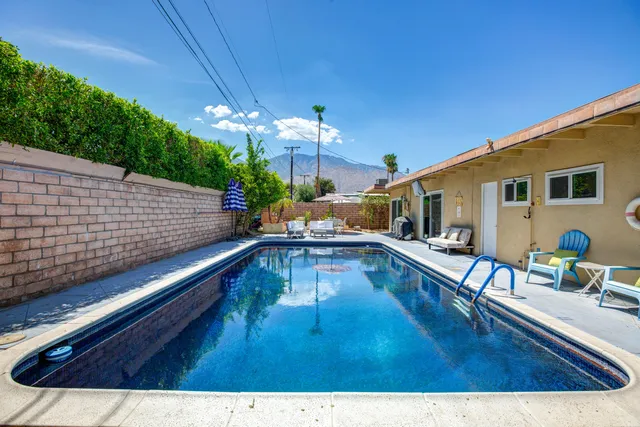 a swimming pool with outdoor seating