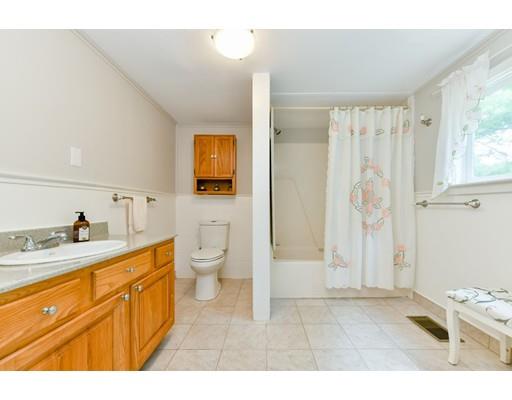 59 Indian Lane Canton, MA 02021 - Photo 6 of 25 a bathroom with a granite countertop sink a toilet a mirror and shower