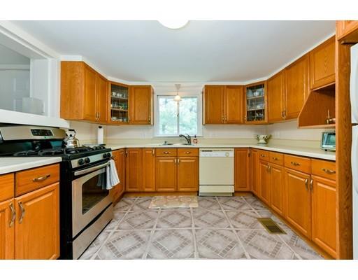 59 Indian Lane Canton, MA 02021 - Photo 8 of 25 a kitchen with stainless steel appliances granite countertop a stove sink and cabinets