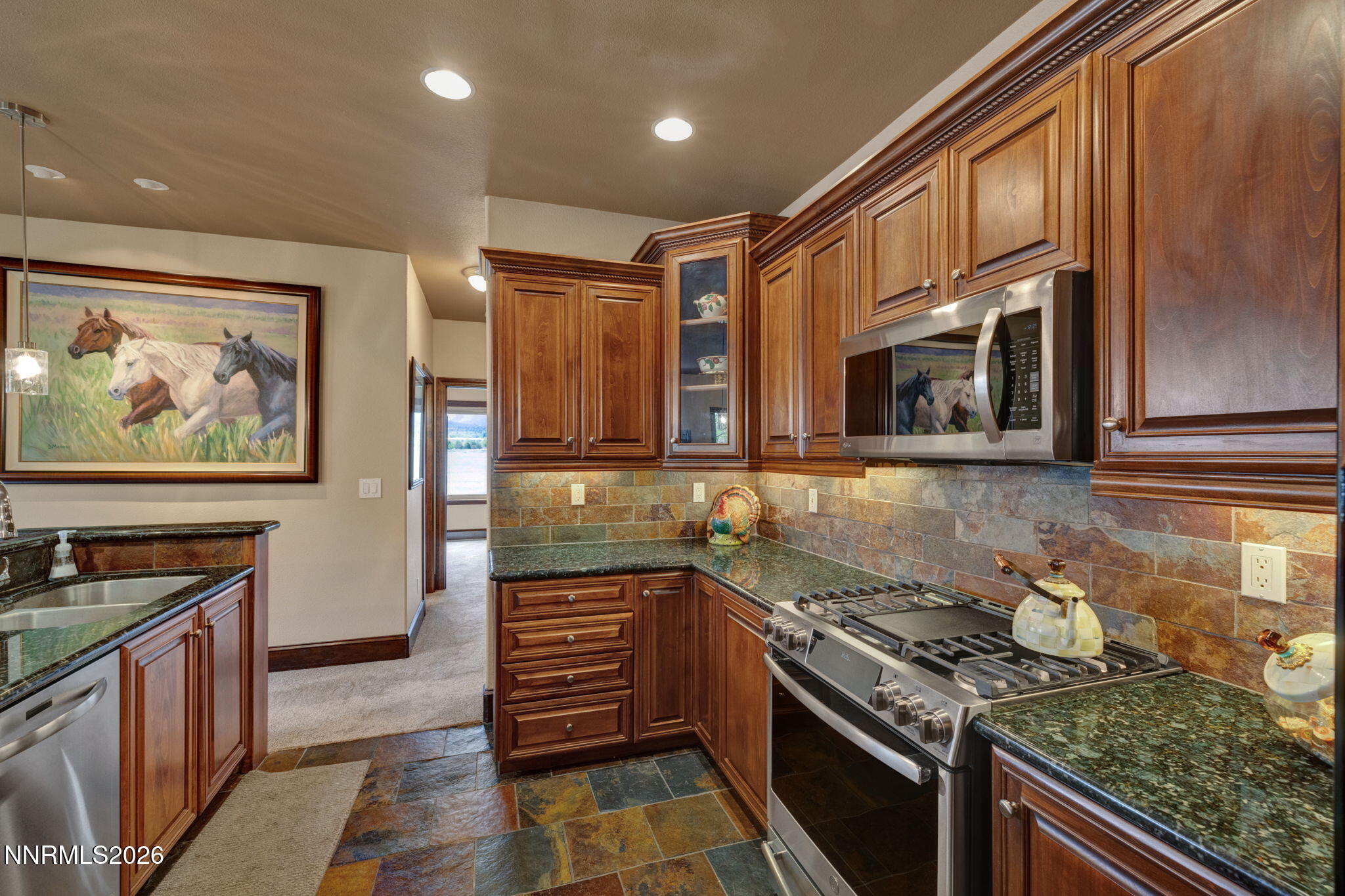900 South Meadows Parkway, Unit 5121 Reno, NV 89521 - Photo 11 of 39 a kitchen with stainless steel appliances granite countertop a stove and a sink