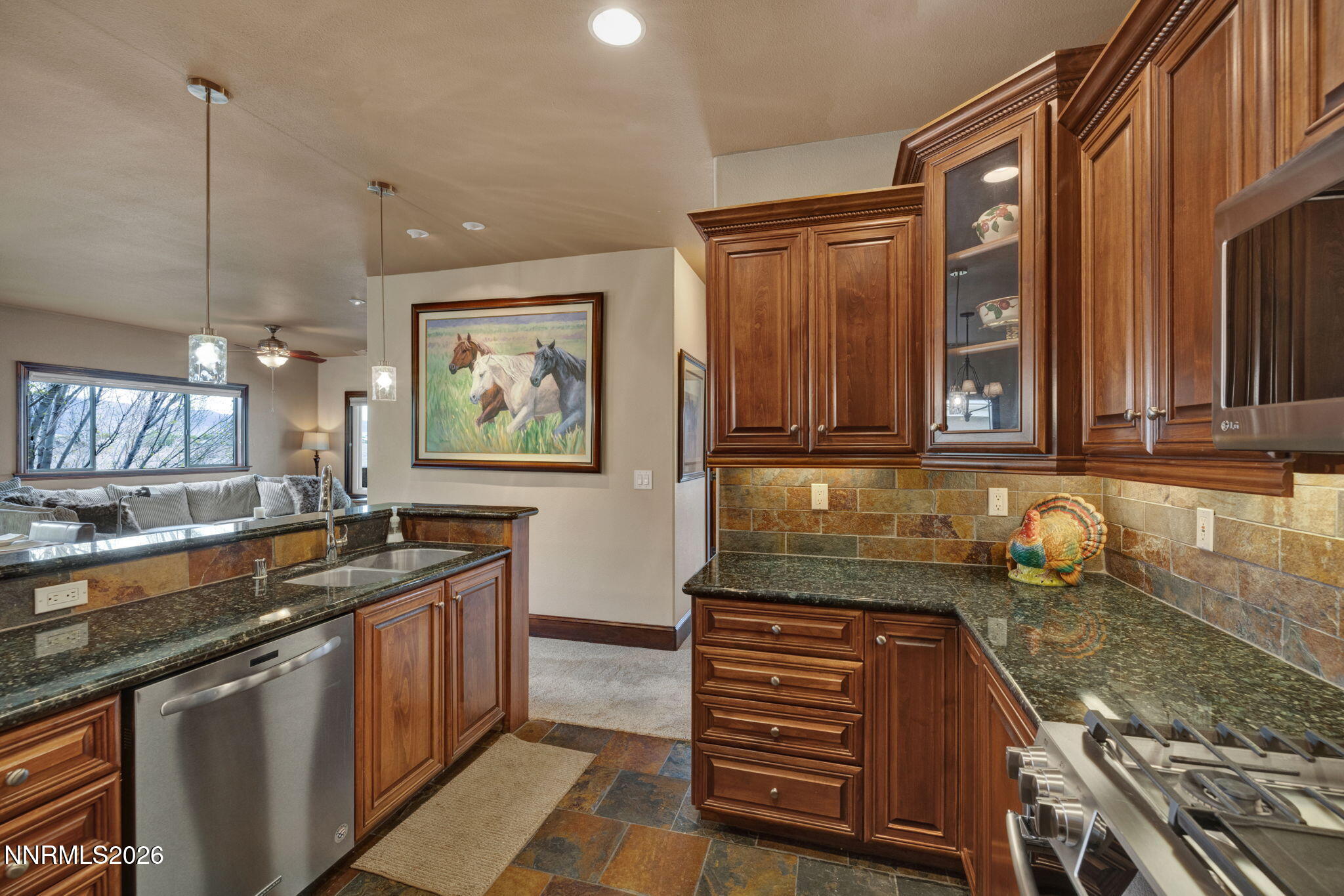 900 South Meadows Parkway, Unit 5121 Reno, NV 89521 - Photo 12 of 39 a kitchen with granite countertop a sink and a stove