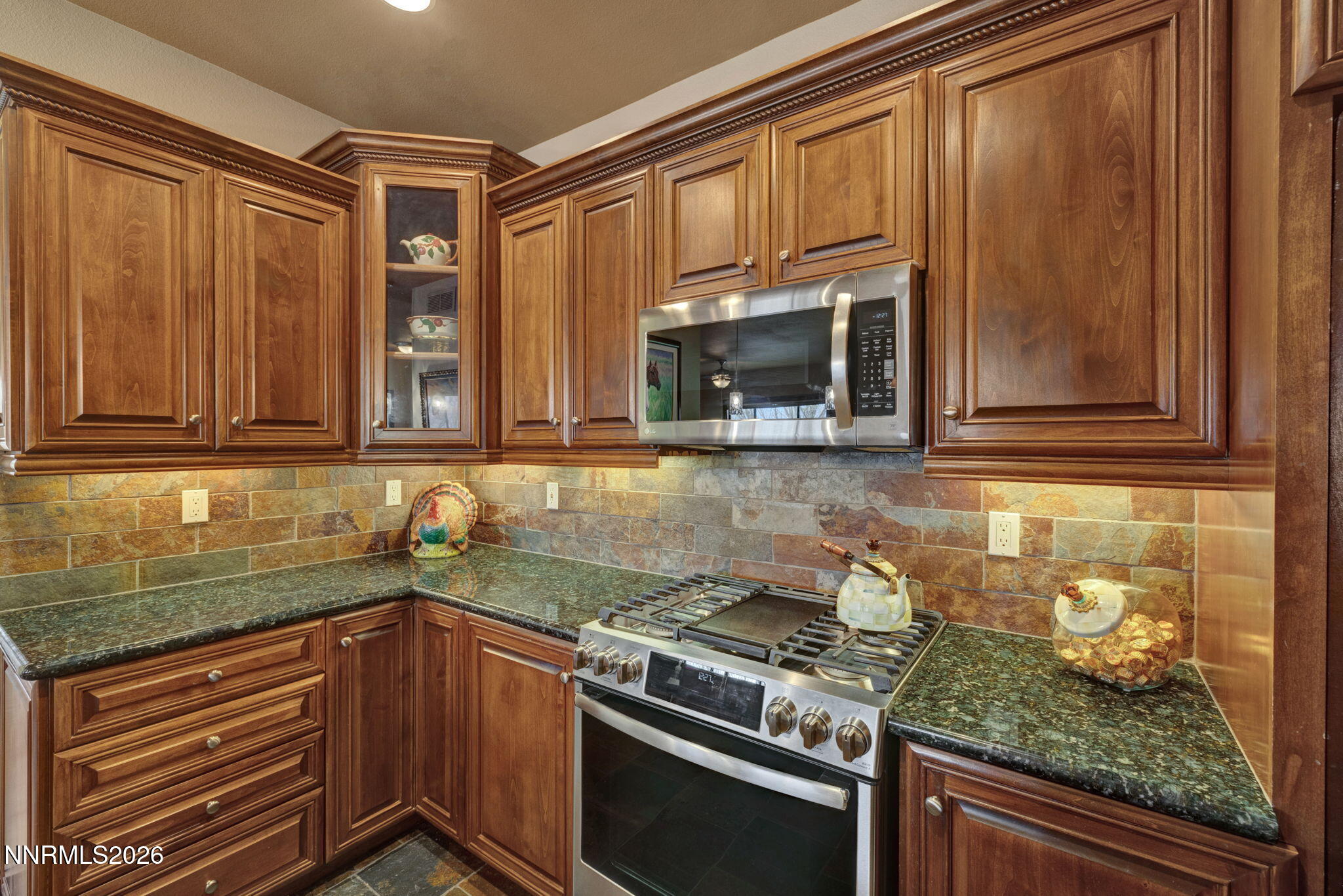 900 South Meadows Parkway, Unit 5121 Reno, NV 89521 - Photo 14 of 39 a kitchen with granite countertop cabinets stainless steel appliances and a sink