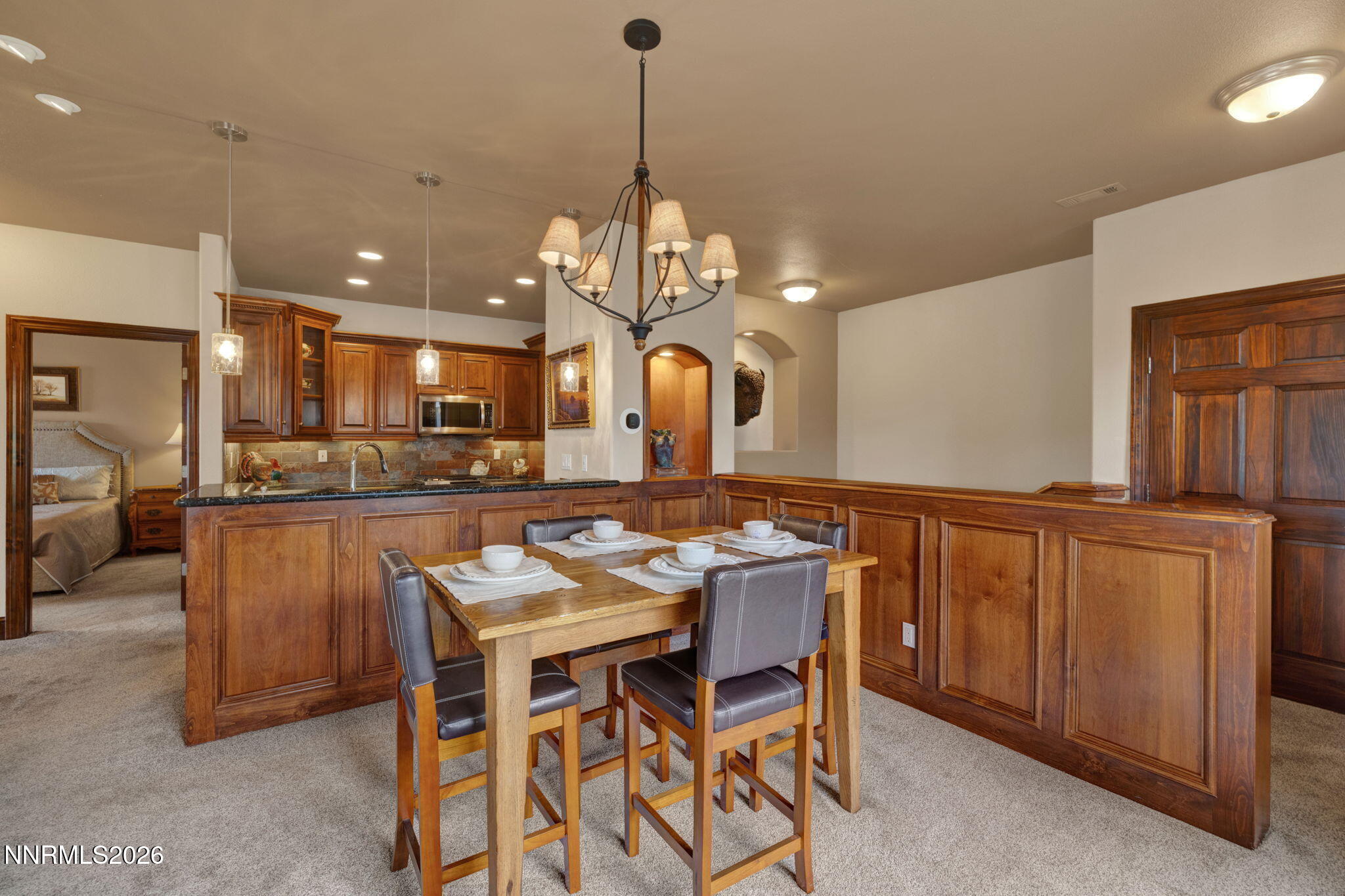 900 South Meadows Parkway, Unit 5121 Reno, NV 89521 - Photo 24 of 39 a kitchen with a dining table chairs sink and cabinets