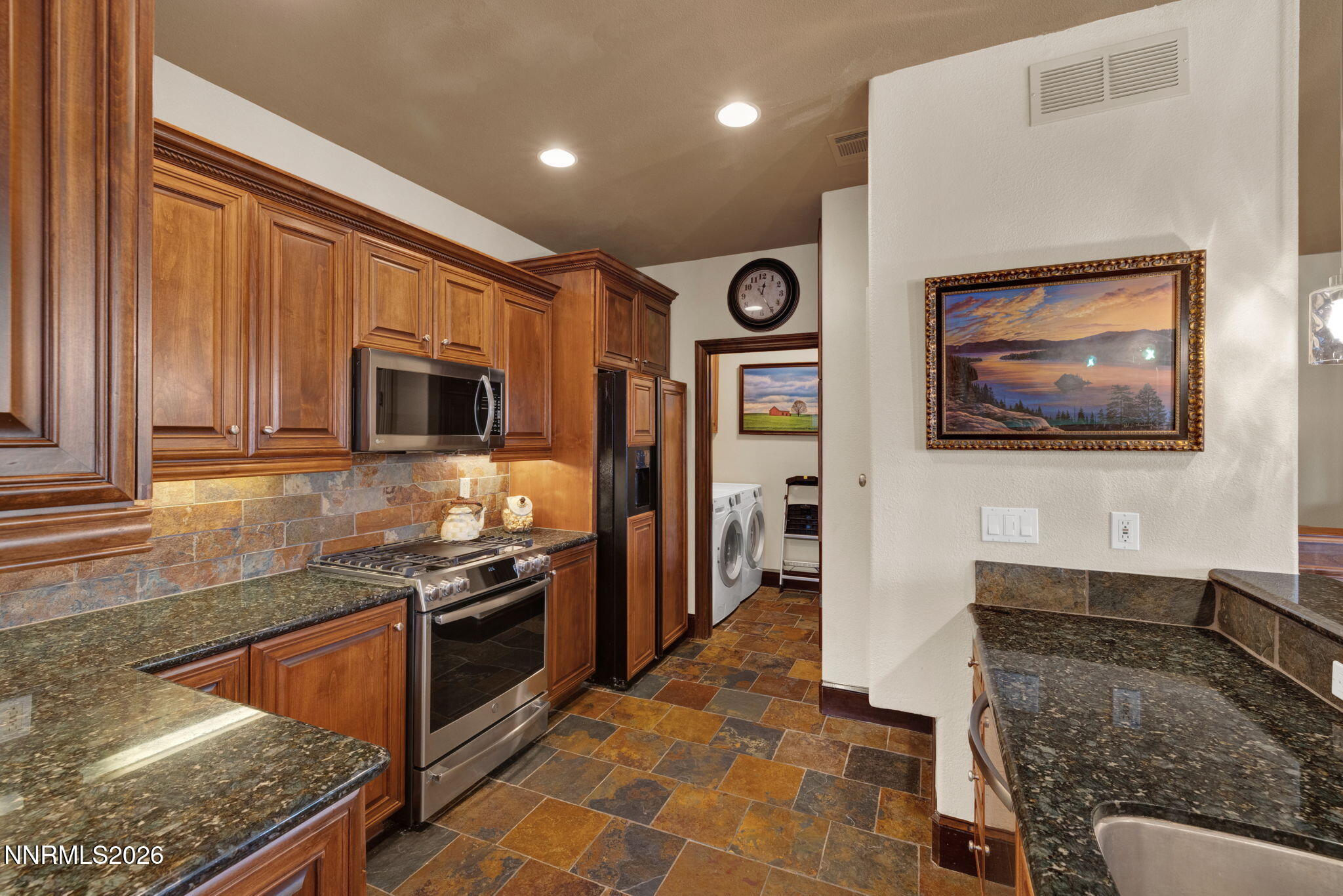 900 South Meadows Parkway, Unit 5121 Reno, NV 89521 - Photo 10 of 39 a kitchen with stainless steel appliances granite countertop a stove top oven a sink a counter space and cabinets