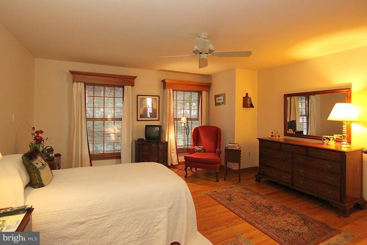 1200 Ashton Road Ashton, MD 20861 - Photo 12 of 30 a bed room with a bed mirror and a window