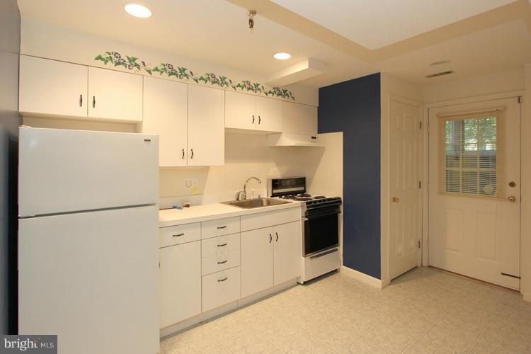 1200 Ashton Road Ashton, MD 20861 - Photo 16 of 30 a kitchen with cabinets a refrigerator and a stove