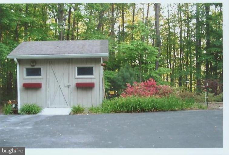 1200 Ashton Road Ashton, MD 20861 - Photo 24 of 30 a front view of a house with a yard and garage