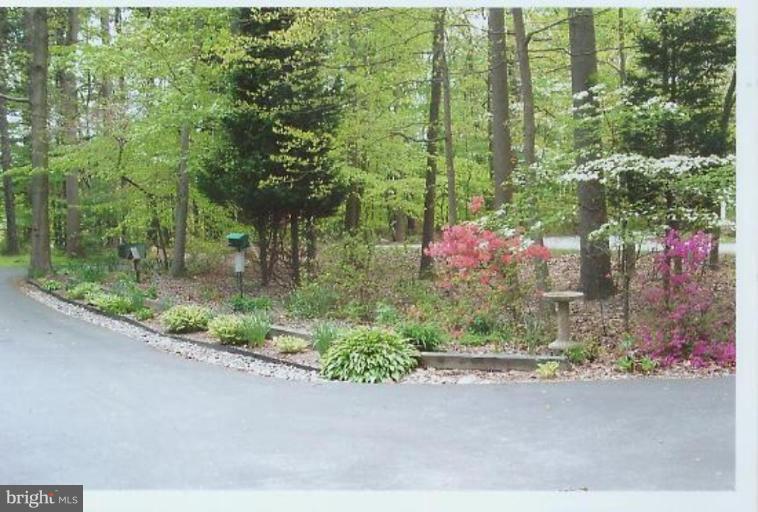 1200 Ashton Road Ashton, MD 20861 - Photo 27 of 30 a backyard of a house with a garden and plants