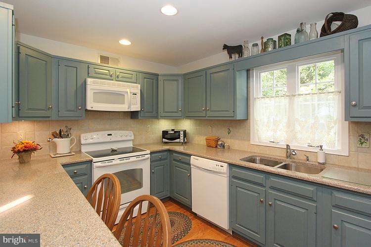 1200 Ashton Road Ashton, MD 20861 - Photo 9 of 30 a kitchen with a sink a stove and cabinets