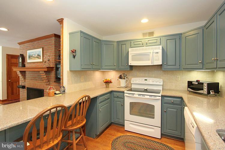 1200 Ashton Road Ashton, MD 20861 - Photo 10 of 30 a kitchen with stainless steel appliances granite countertop a stove a sink and a refrigerator