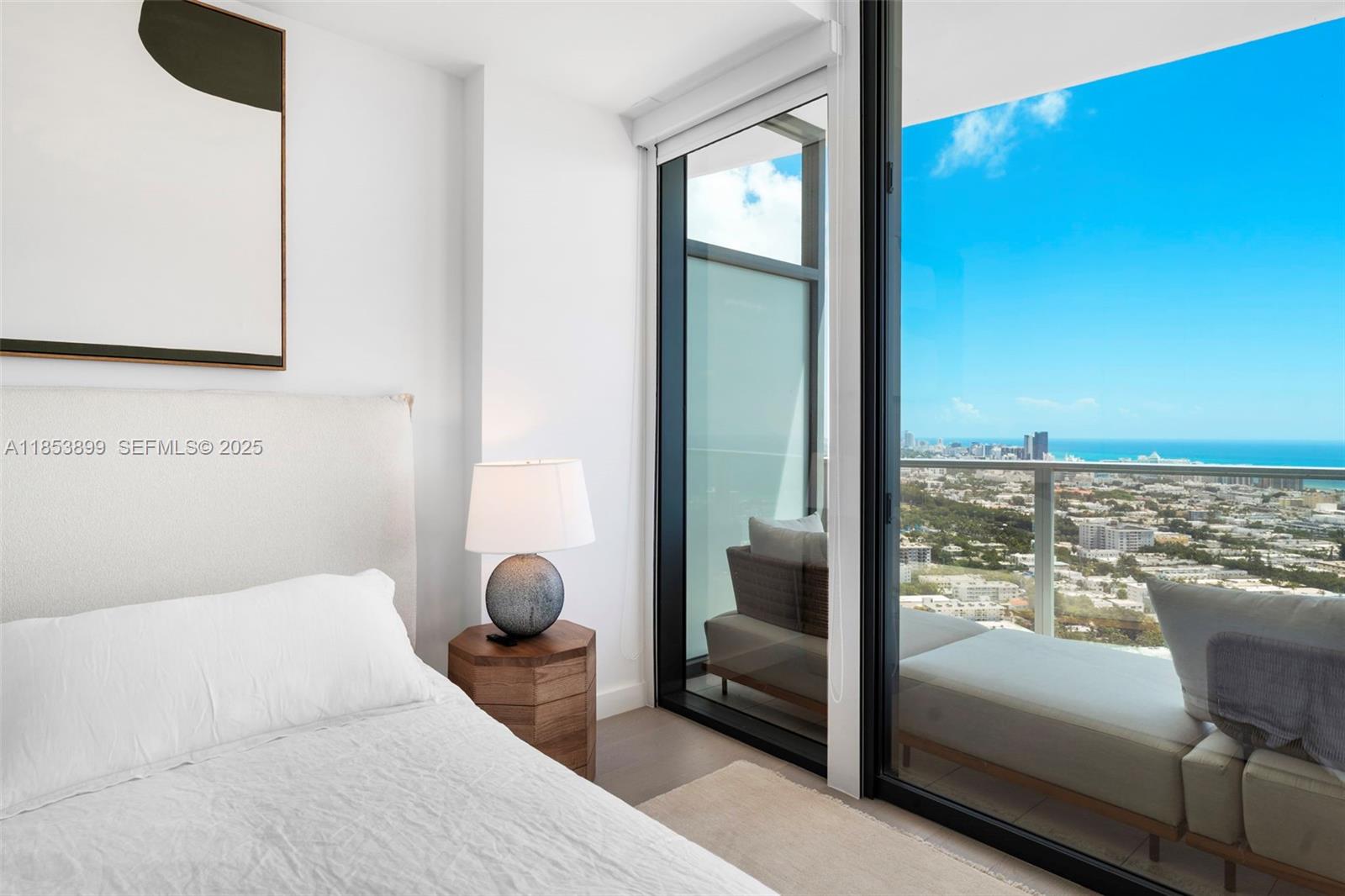 500 Alton Road, Unit 3604 Miami Beach, FL 33139 - Photo 13 of 45 a bedroom with furniture and a large window