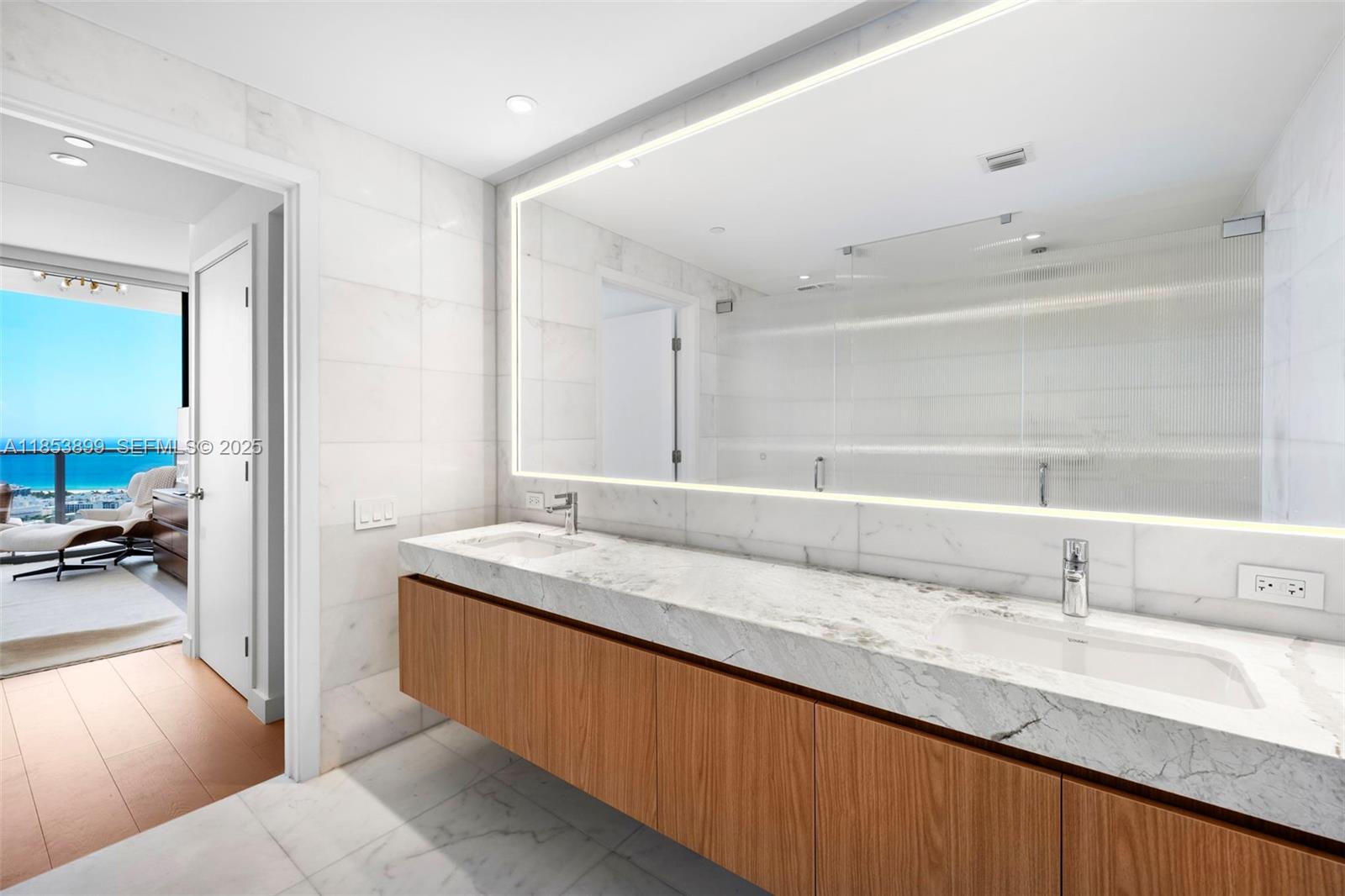 500 Alton Road, Unit 3604 Miami Beach, FL 33139 - Photo 15 of 45 a bathroom with a granite countertop sink a large mirror and vanity