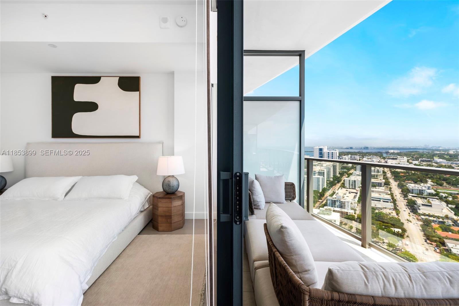 500 Alton Road, Unit 3604 Miami Beach, FL 33139 - Photo 25 of 45 a bedroom with a bed and glass window