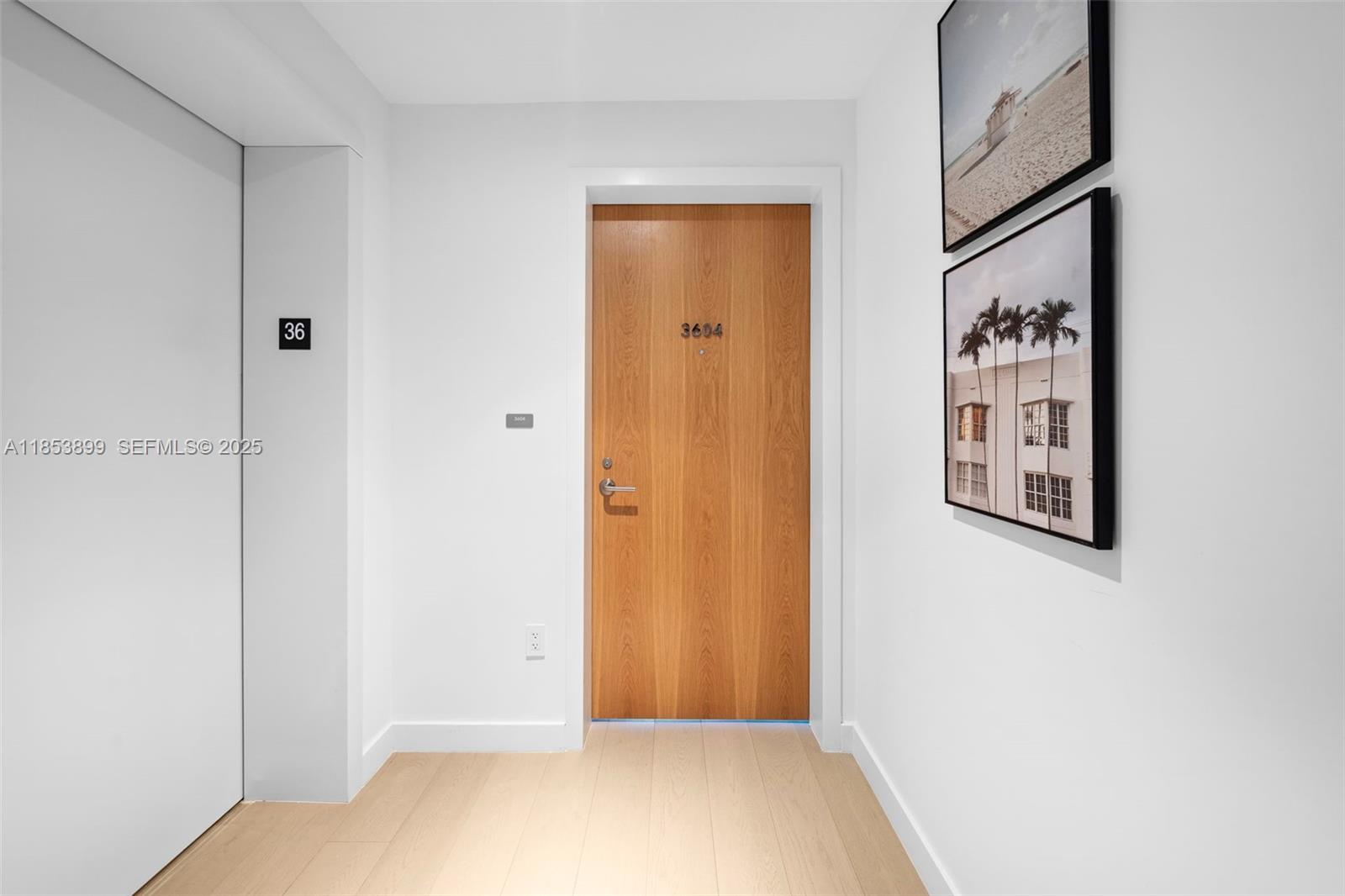 500 Alton Road, Unit 3604 Miami Beach, FL 33139 - Photo 26 of 45 a view of a hallway with paintings on the wall