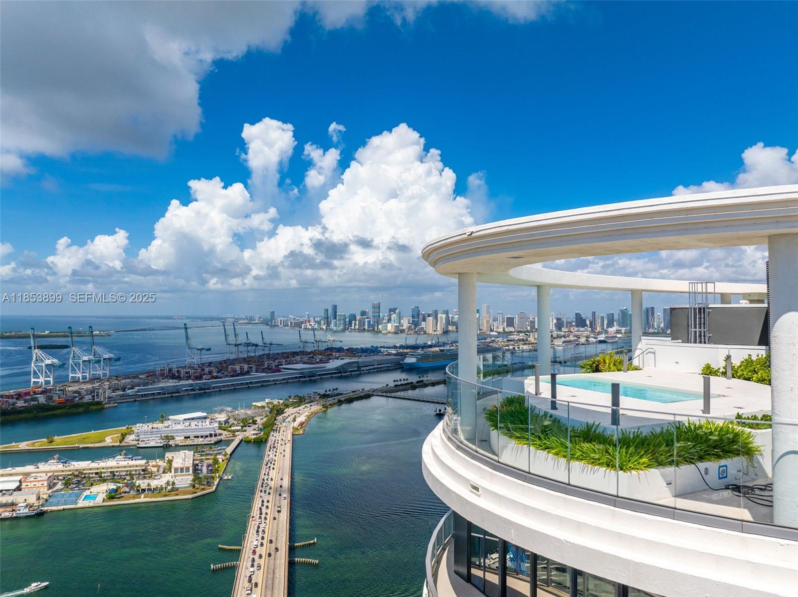 500 Alton Road, Unit 3604 Miami Beach, FL 33139 - Photo 29 of 45 a view of a swimming pool with a table and chairs in patio