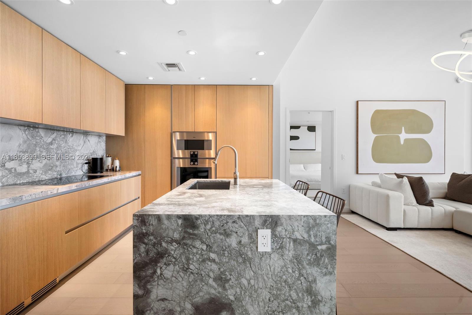 500 Alton Road, Unit 3604 Miami Beach, FL 33139 - Photo 4 of 45 a large kitchen with stainless steel appliances kitchen island granite countertop a sink and cabinets