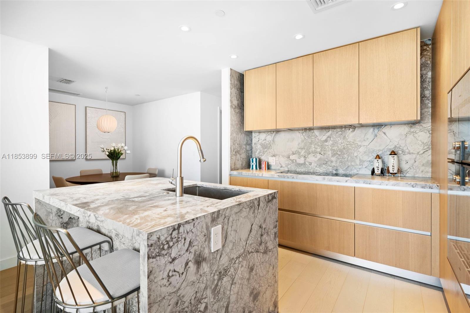 500 Alton Road, Unit 3604 Miami Beach, FL 33139 - Photo 8 of 45 a kitchen with stainless steel appliances granite countertop a table chairs sink and cabinets