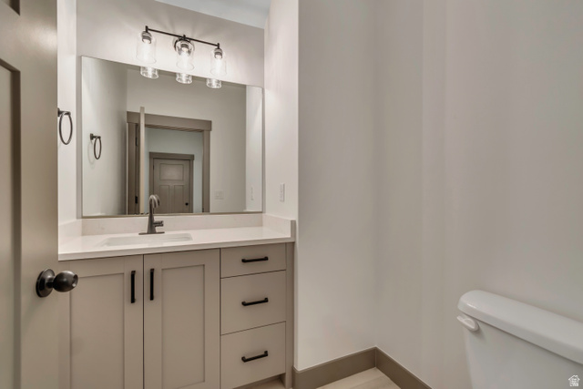 3317 South 1000 West, Unit 6010 Logan, UT 84321 - Photo 20 of 34 Half bathroom with vanity and toilet