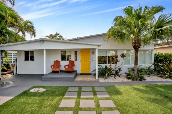 a front view of house with yard and outdoor seating